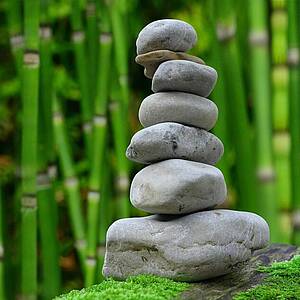 6 gestapelte Steine vor Bambusstäben